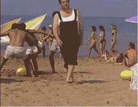 沙滩上男子以为黄色泳帽是足球，一脚踢过去踢到别人的头